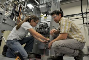 Energy Services & Technology students at KVCC learn advanced skills in multiple technical areas. The female student in the photo hopes to return to the program in the future; the male student is a veteran with a bachelor's degree who wants a more hands-on career. 