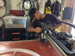 Florida Keys Community College student Cody Moore uses a 3-D printer as he helps with prototype development at Hydrokinetic Energy Corp. The paid internship at the company in spring 2019 is the capstone experience of his Engineering Technology-Renewable Energy Technician degree.