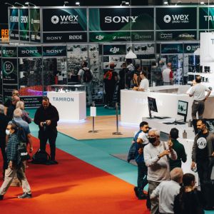 A photo of the inside of a conference center, with booths and people milling about