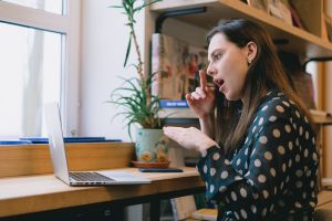 A woman using American Sign Language in a video conference